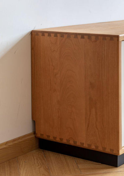 Wooden cabinet against a white wall with a wooden floor.
