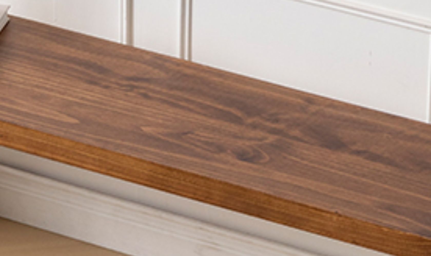 Wooden step with a white wall in the background