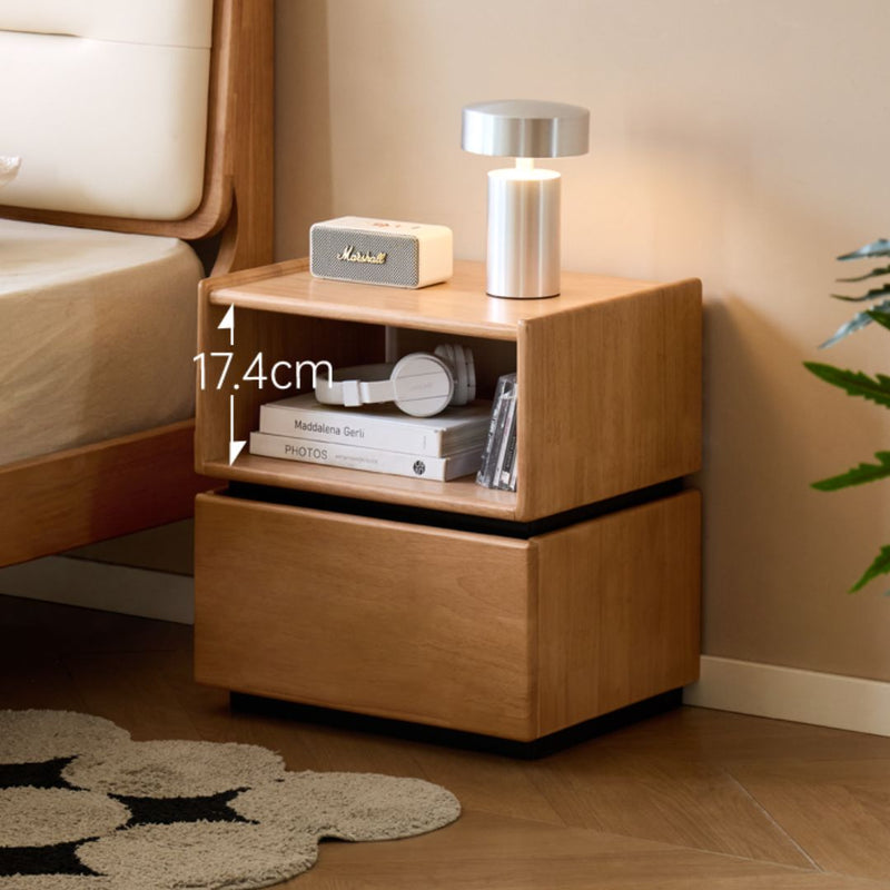 Wooden nightstand with lamp and books in a bedroom setting