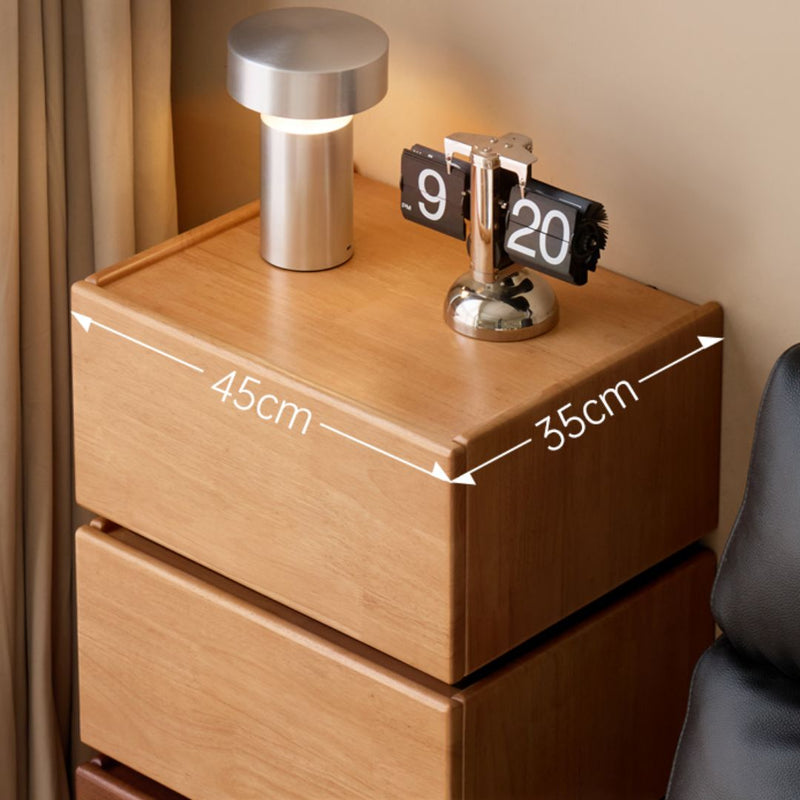 Wooden nightstand with a lamp and digital clock, showing dimensions.