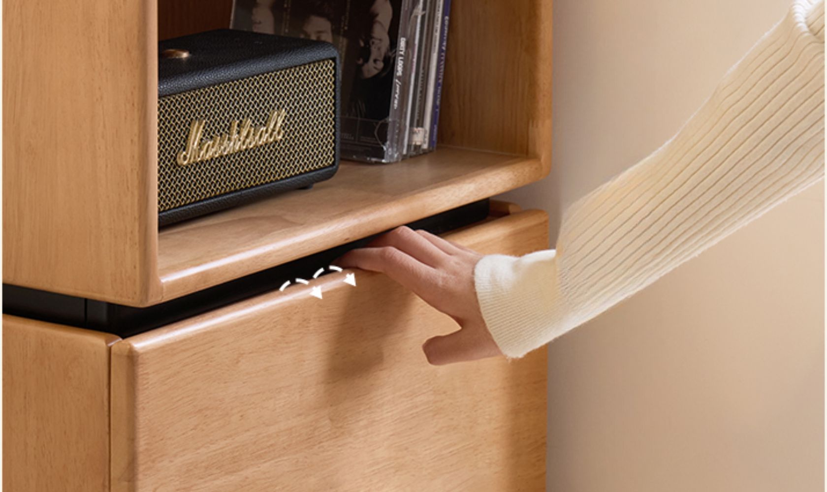 Marshall speaker on a wooden shelf with a hand reaching towards it